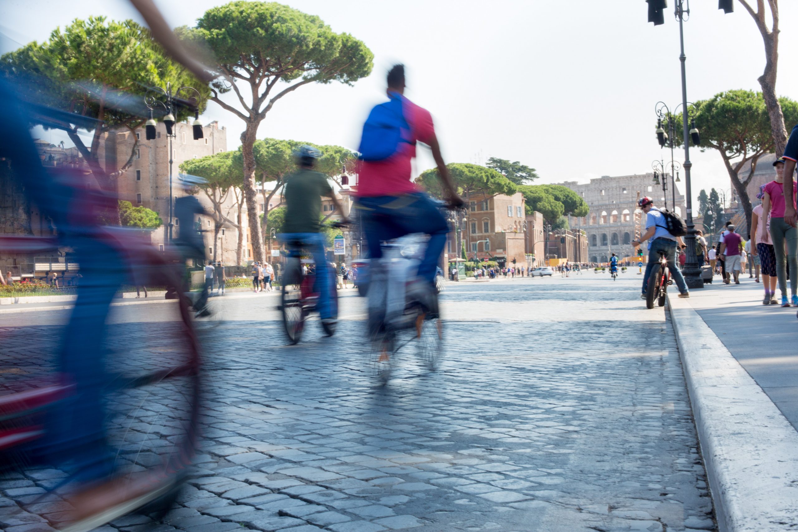 Rome_bike Man charging electric car while holding smartphone